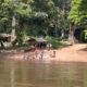 indigenous people on riverbank, children bathing, playing